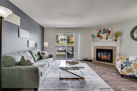 a living room with a fireplace and a green couch