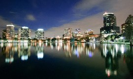 a city skyline at night over a body of water