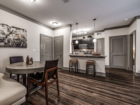 A modern kitchen with a dining table and chairs.