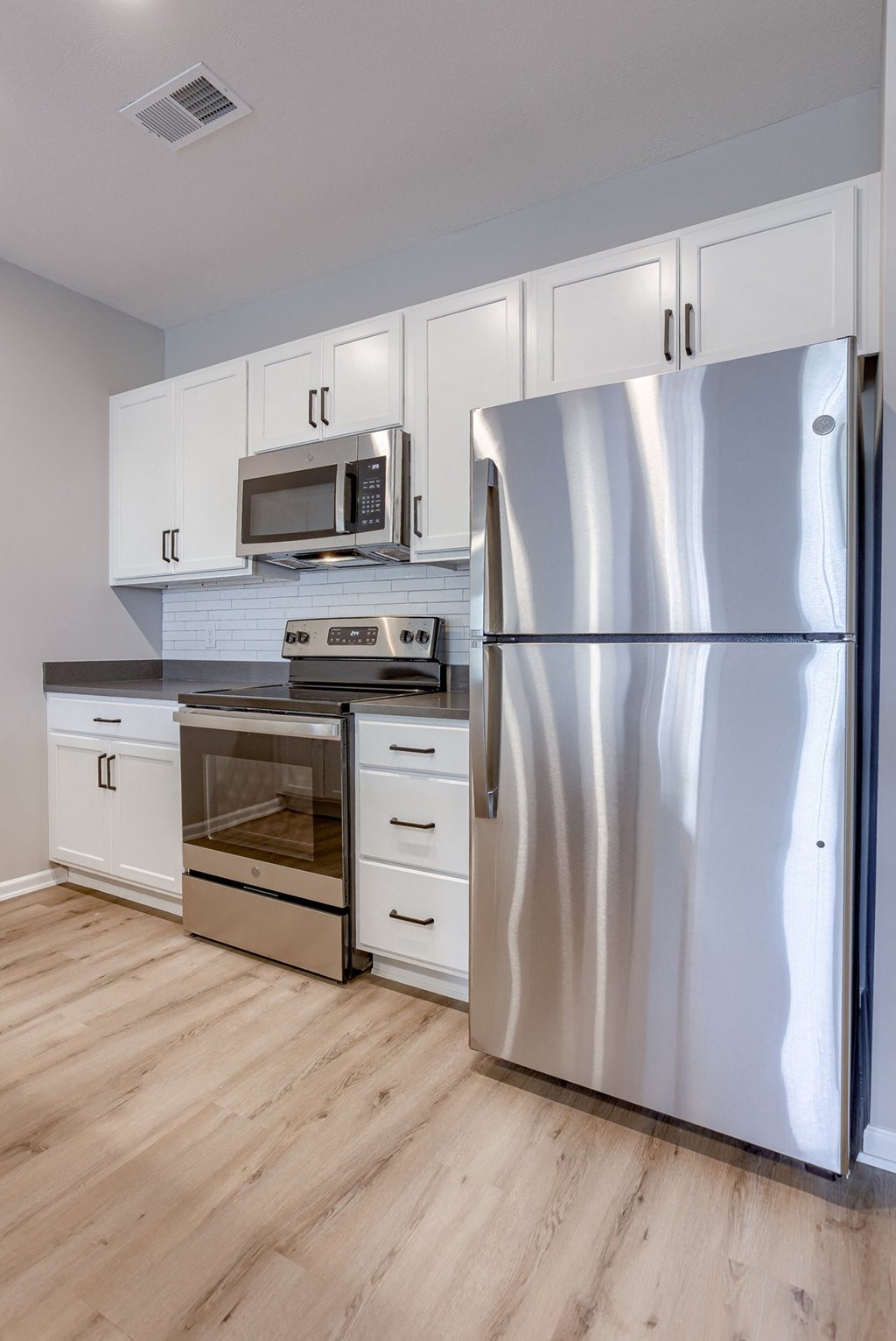 Kitchen with White Cabinetry and Stainless Steel Appliances