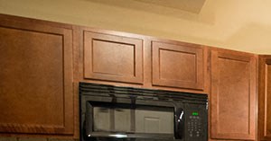 Spacious Kitchen with Quartz Countertops and Black Appliances and Large Breakfast Bar