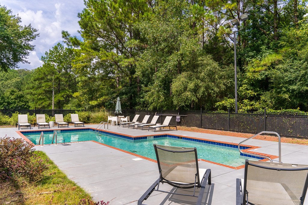Pool & Sundeck Surrounded By Lush Trees & Landscaping