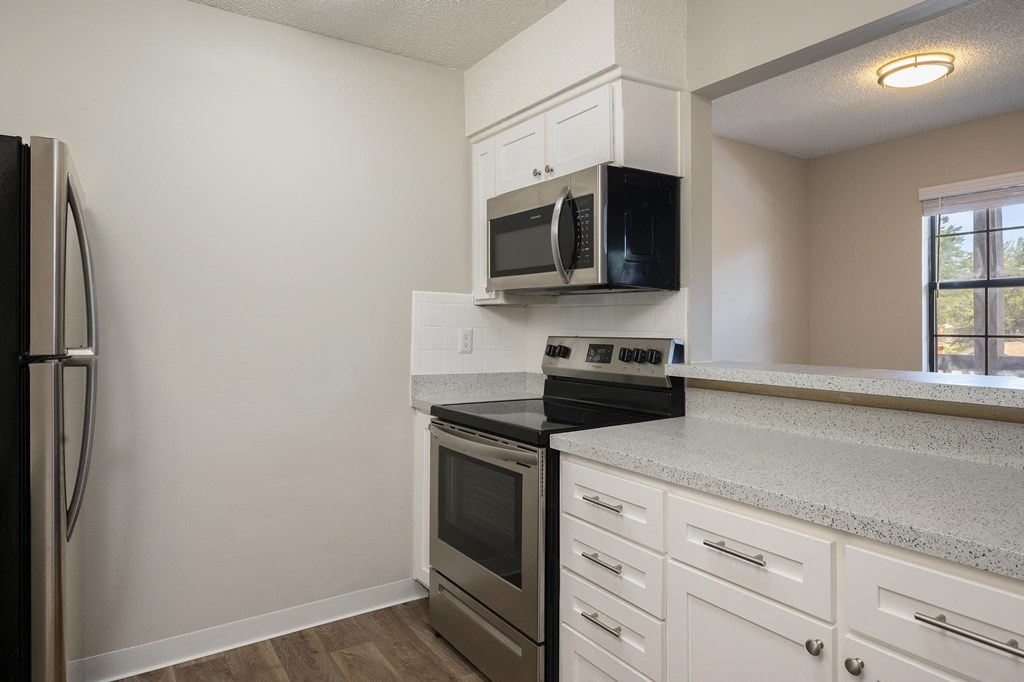 Kitchen With Brushed Nickel Hardware & White Cabinetry