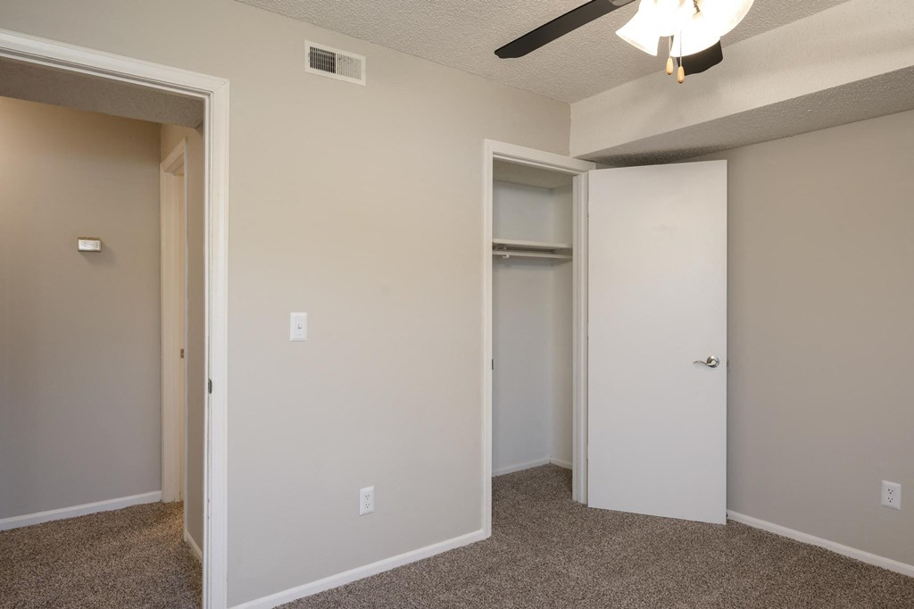 Bedroom With Plush Carpeting & Ceiling Fan With Light