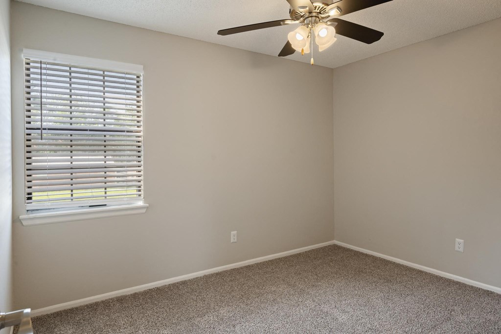 Bedroom With Plush Carpeting & Large Window