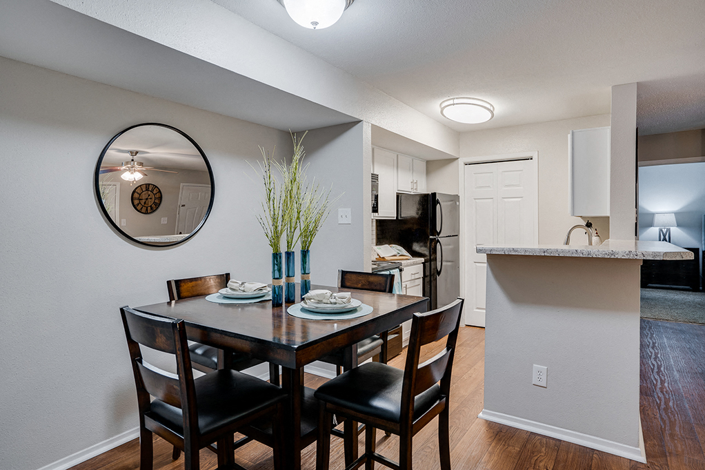 A dining room with a table set for two.