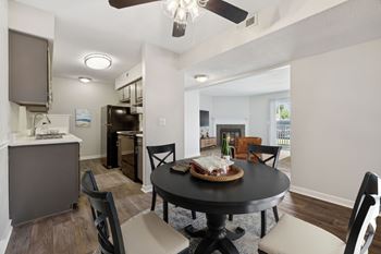 A dining room with a table set for four.