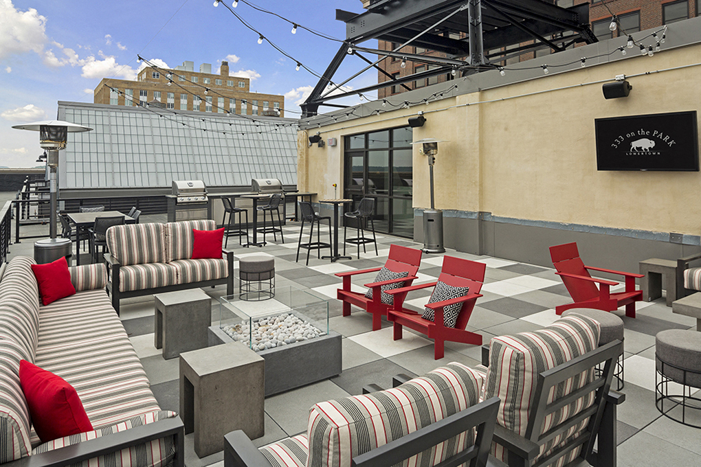 Rooftop Patio with Fire Pit Under String Lights