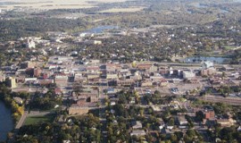 an aerial view of a city with buildings and a lake