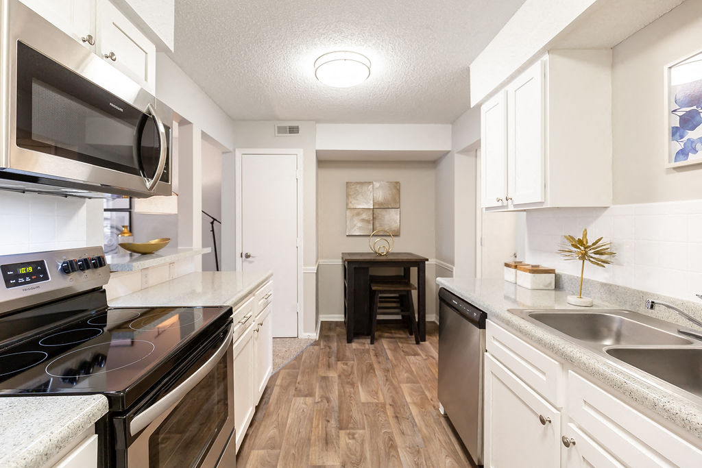 Renovated Kitchen with Stainless Steel Appliances, White Cabinets and Wood Style Flooring