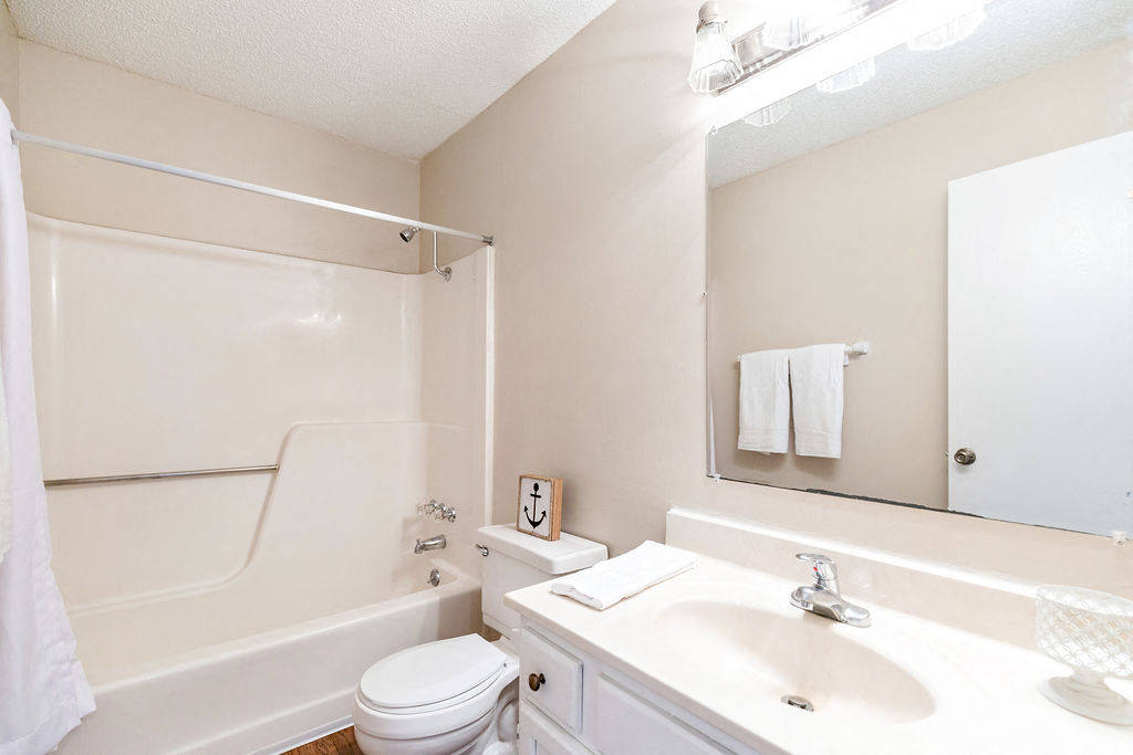 Classic Bathroom with White Vanity and Almond Color Countertop