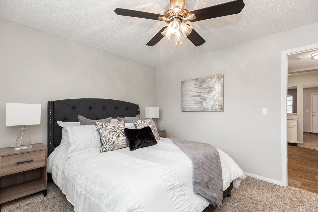 Bedroom with Plush Carpet and Ceiling Fan and Light