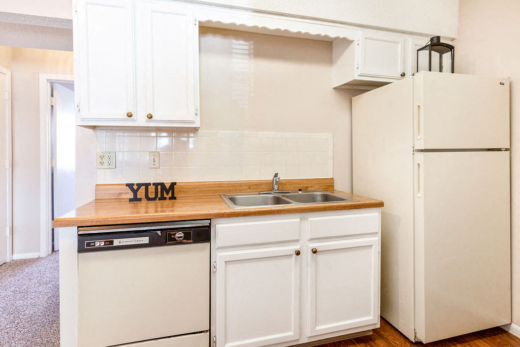Classic Kitchen with White Cabinets and Almond Colored Appliances
