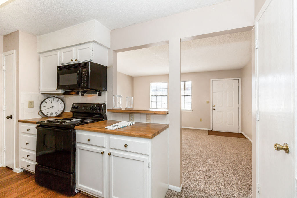 Classic Kitchen with White Cabinets and Black Appliances