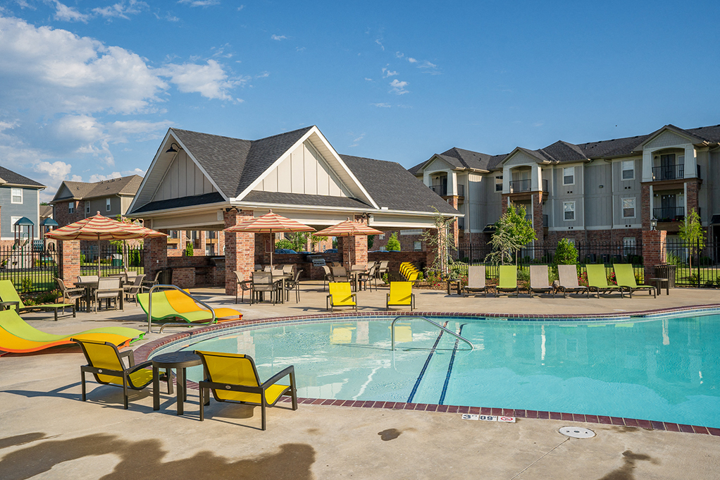 Expansive Pool Area with Lounge Chairs and Sun Umbrellas