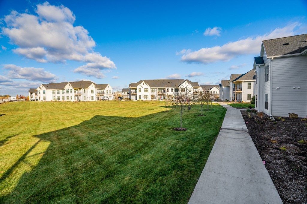 Lush Grass Area Behind Apartment Homes At Sundance Woodbury