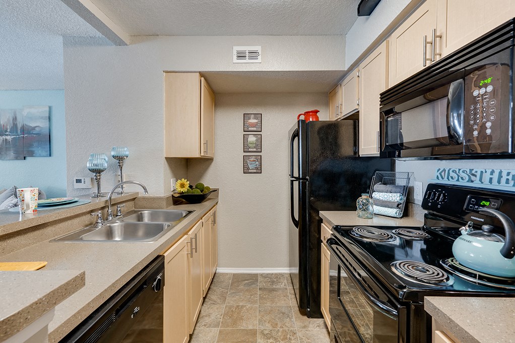 Kitchen with Tiled Flooring and Black Appliances