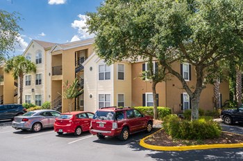 Large Trees Surrounding an Apartment Building at The Carrington at Four Corners - Photo Gallery 5