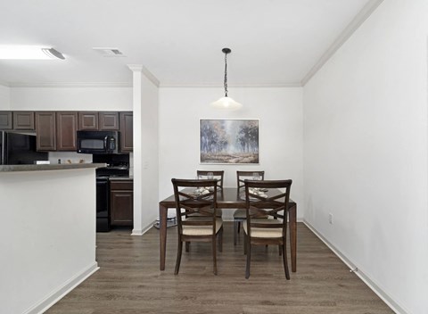 a dining room with a table and chairs and a kitchen