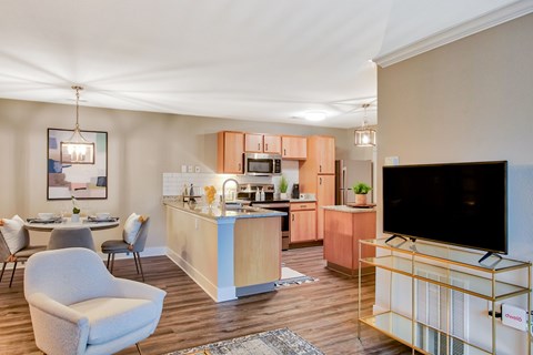 A modern kitchen with a dining table and chairs.
