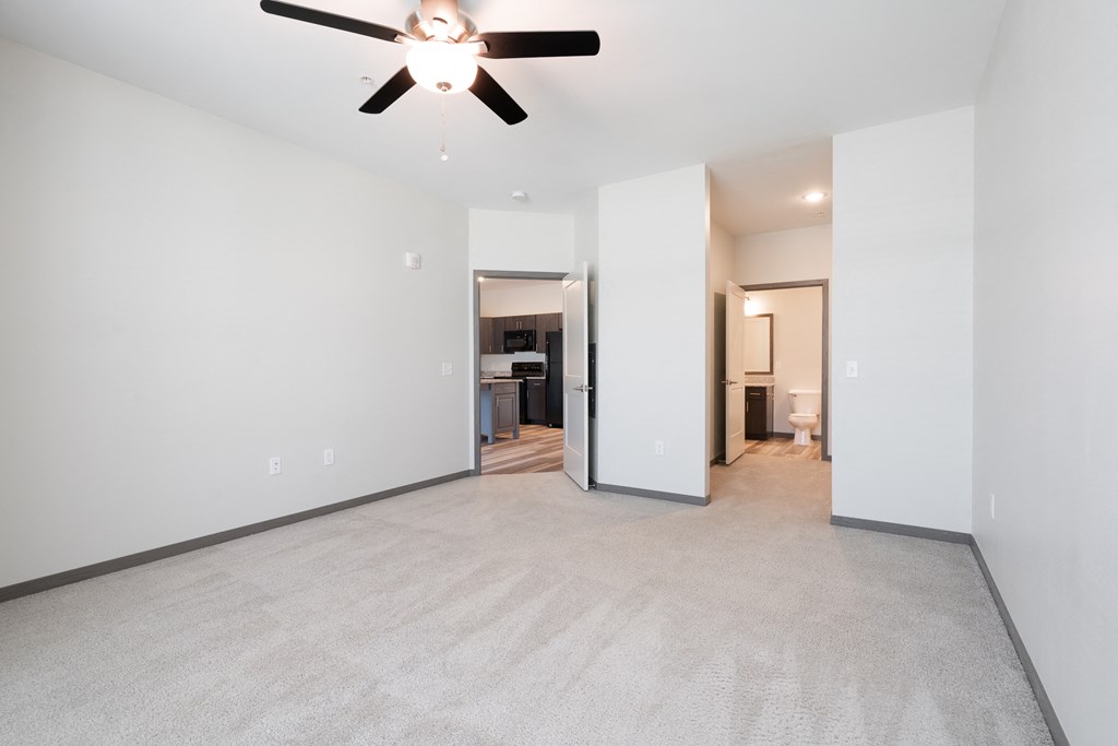 Carpeted Bedroom With Ceiling Fan & Light