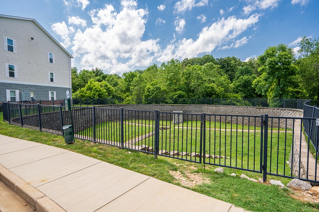 the yard is fenced off with a black metal fence