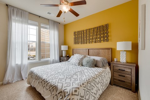 Bedroom With Plush Carpet & Large Windows