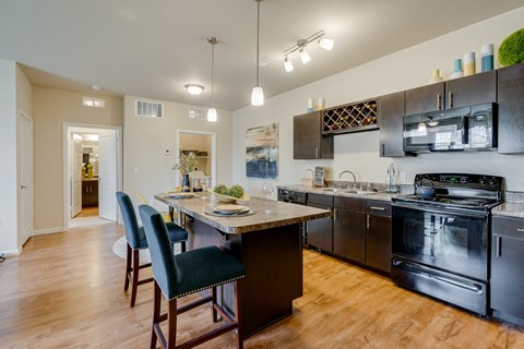 Spacious Kitchen With Bar Stool Seating At The Kitchen Island