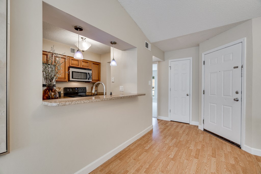 Kitchen With Peek Through Window With Countertop Breakfast Bar