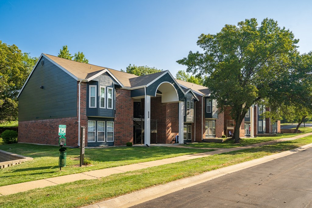 Exterior Of Apartment Homes At Willowbend Surrounded With Lush Grass