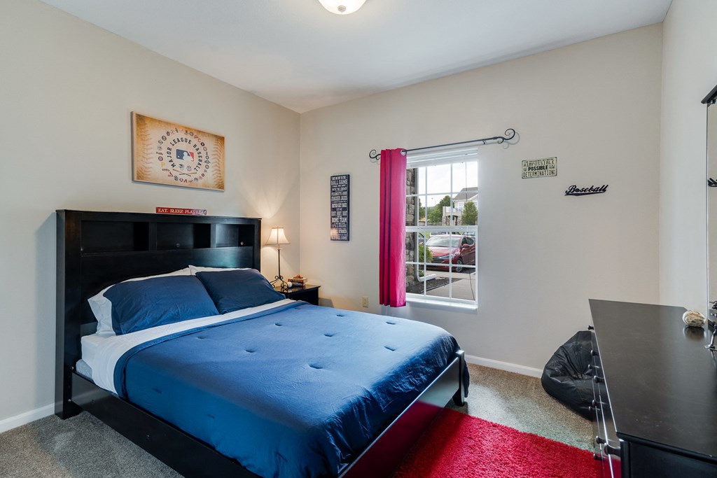 Bedroom with Large Window and Ceiling Light