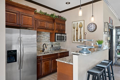 a kitchen with stainless steel appliances and wooden cabinets