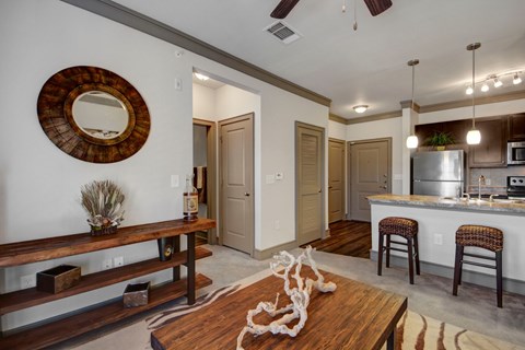 A modern kitchen with a wooden table and chairs.