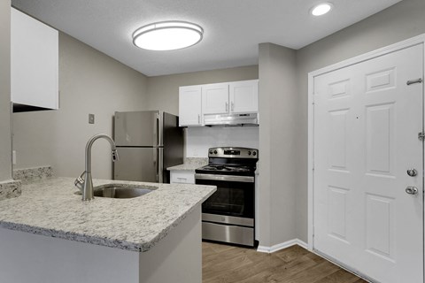 a kitchen with granite counter tops and stainless steel appliances