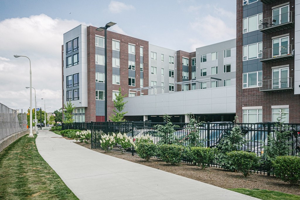Bike path located behind apartment building with landscaping and lighting