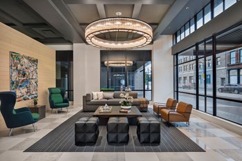 Lobby at Quarter Ohio City apartment building with chandelier and seating - Photo Gallery 2