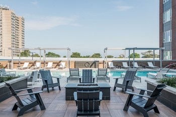 Pool deck with groupings of adirondack chairs and a fire pit - Photo Gallery 15