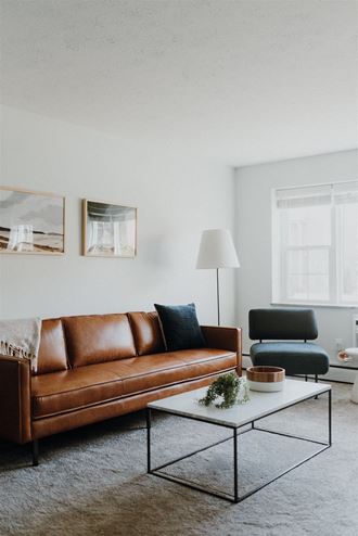 a living room with a leather couch and a coffee table