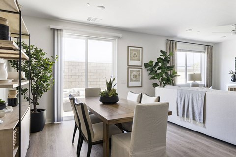 A dining room with a table set for four.