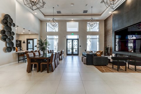 A modern dining room with a long table and chairs.