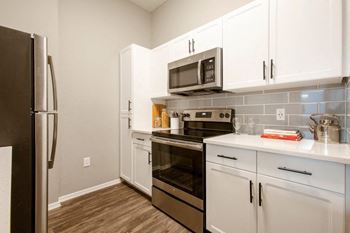 a kitchen with white cabinets and stainless steel appliances at Ascent North Scottsdale Apartments, Phoenix, AZ 85054
