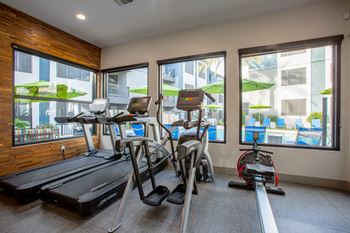 a gym with cardio equipment and a view of the pool at Ascent North Scottsdale Apartments, Phoenix, 85054