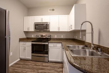 a kitchen with white cabinets and granite countertops at Ascent North Scottsdale Apartments, Arizona, 85054