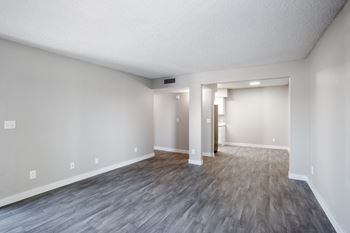 an empty living room with a hardwood floor at Ascent on Pantano Apartments, Tucson, Arizona