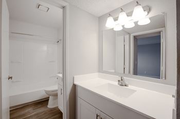 a bathroom with a sink and a toilet at Ascent on Pantano Apartments, Tucson, AZ 85710