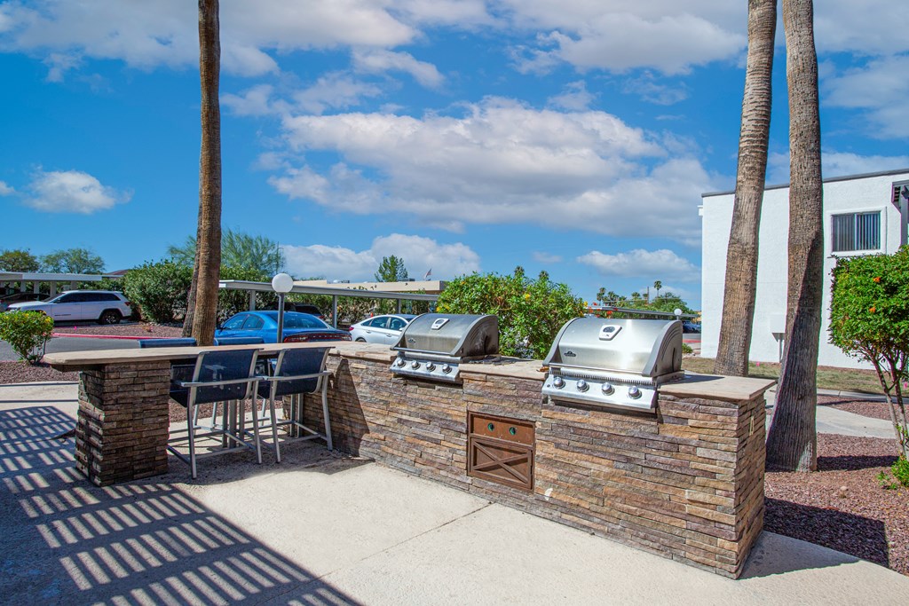 our apartments have an outdoor kitchen with a grill and bbq