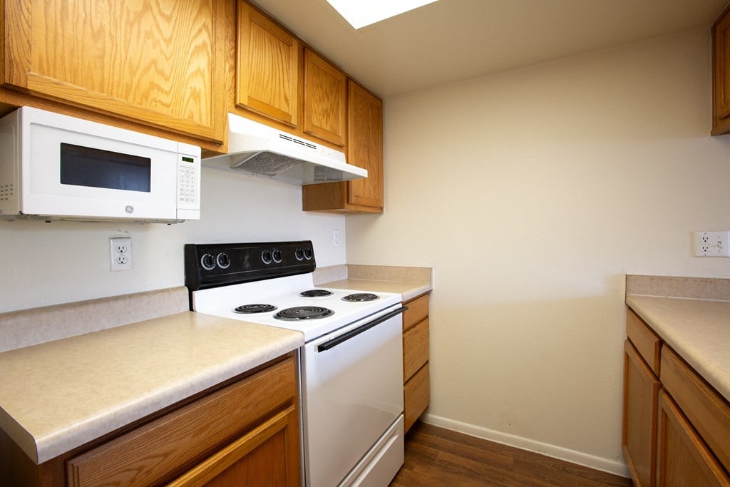 A kitchen with a white oven and microwaveat Ascent on Spence, Arizona.