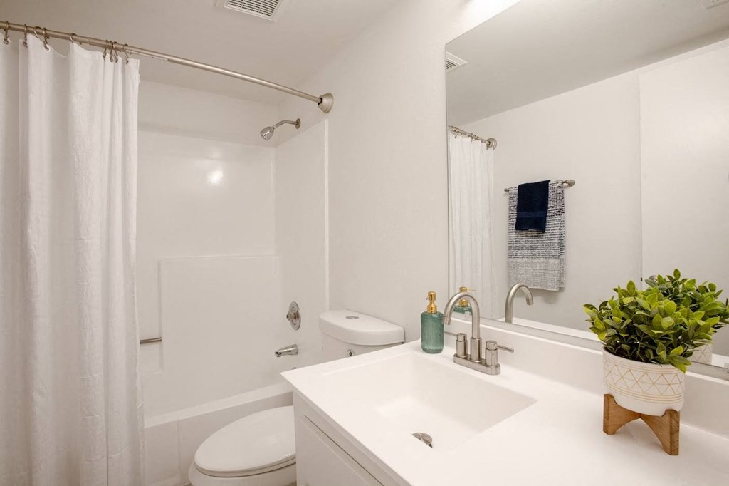 a bathroom with a sink toilet and shower at Ascent on Peoria Apartments, Phoenix