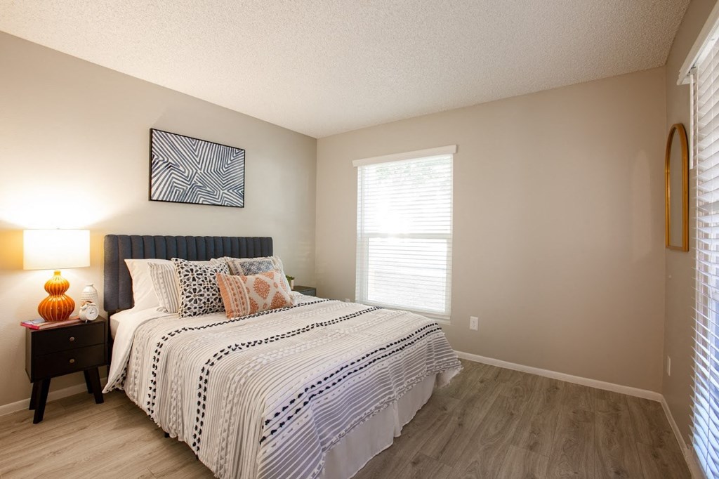 a bedroom with a bed and a window