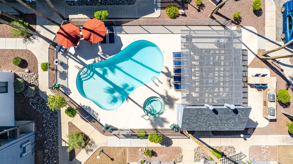 an aerial view of a building with a blue pool in the middle of it